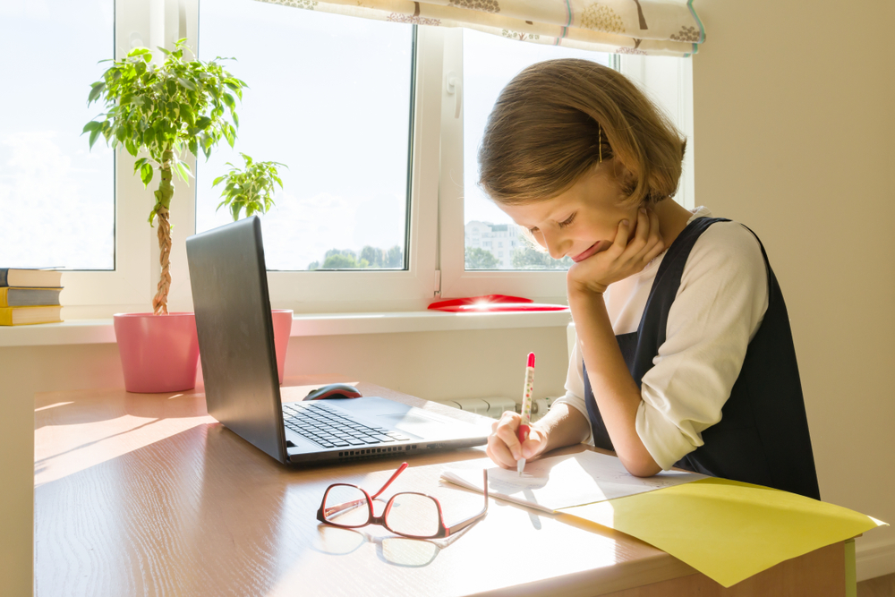 Schoolgirl,,Girl,Of,8,Years,,Sitting,At,Table,With,Books