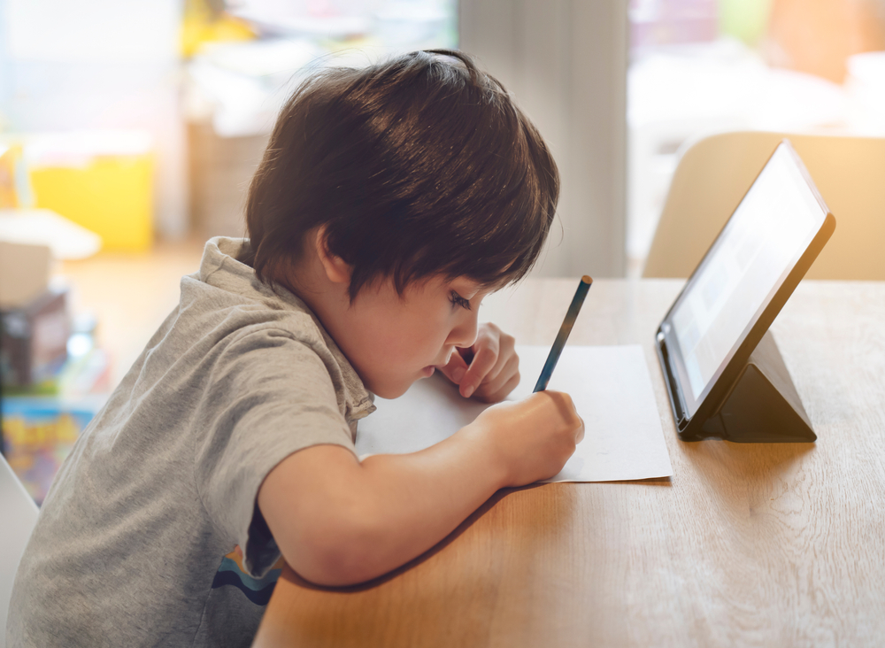 Portrait,Of,Preschool,Kid,Using,Tablet,For,His,Homework,soft,Focus