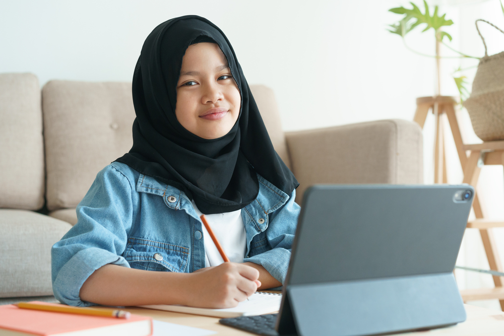 Muslim,Girl,Is,Studying,Online,Via,The,Internet,On,Tablet