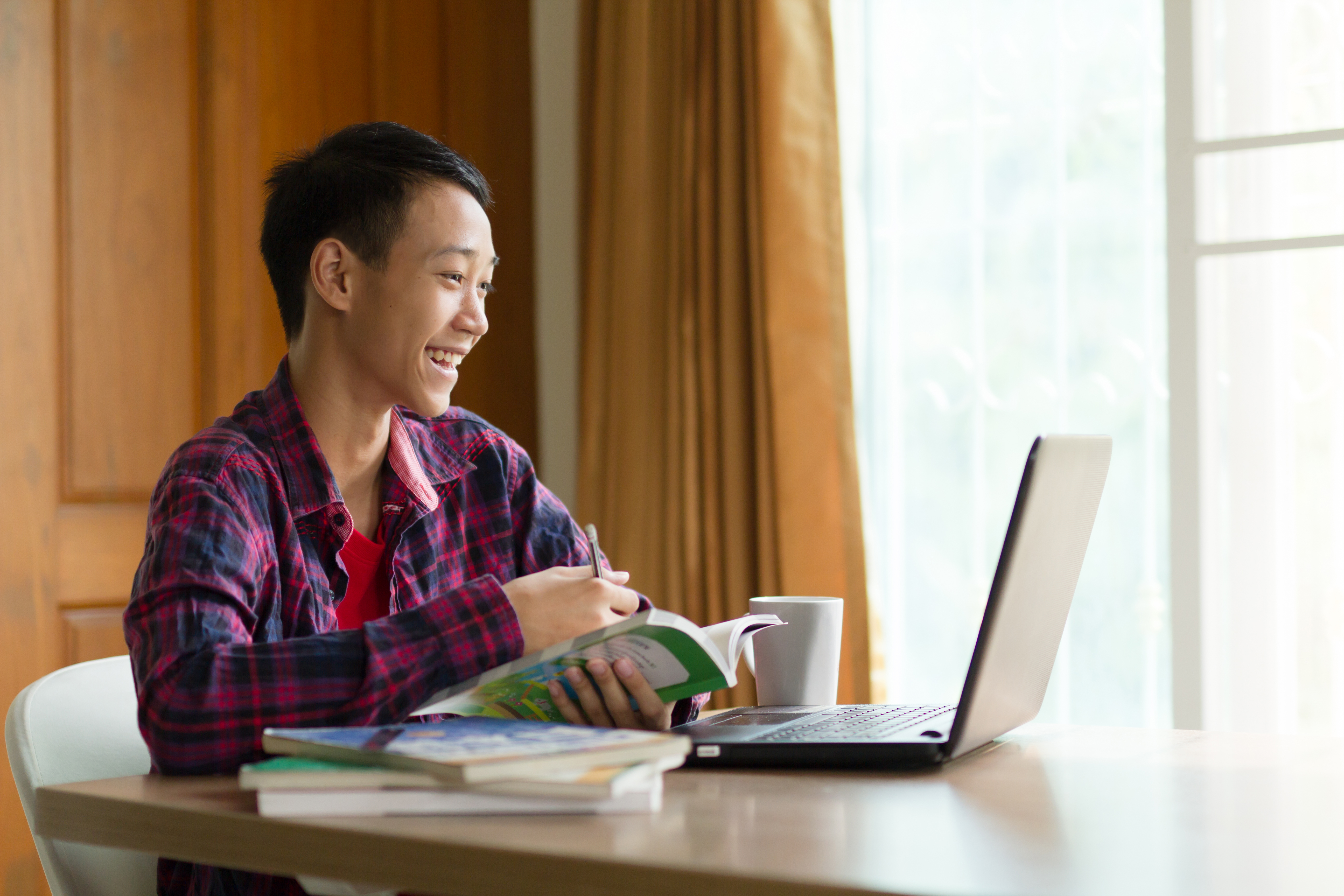 Asia,Teenage,Boy,Studying,Online,On,Laptop,With,Smiling,And